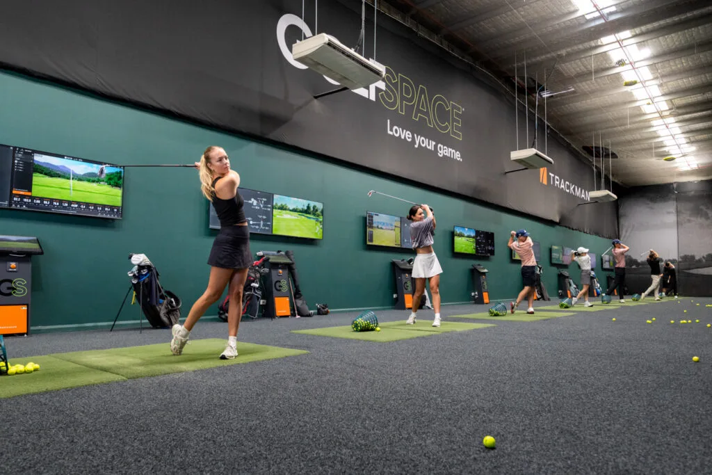 Golfers practising in the GolfSpace TrackMan simulator bays in Alexandria.